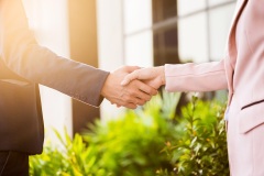 closeup-friendly-meeting-handshake-business-woman-businessman-with-sunlight